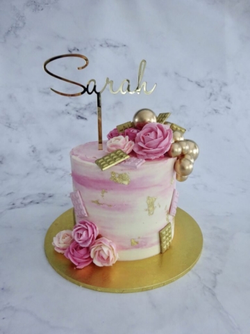 "Marbled Pink Cake with Piped Roses and Gold Balls"
