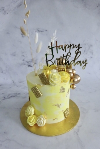 "Marbled Lemon Cake with Piped Roses and Gold Balls"
