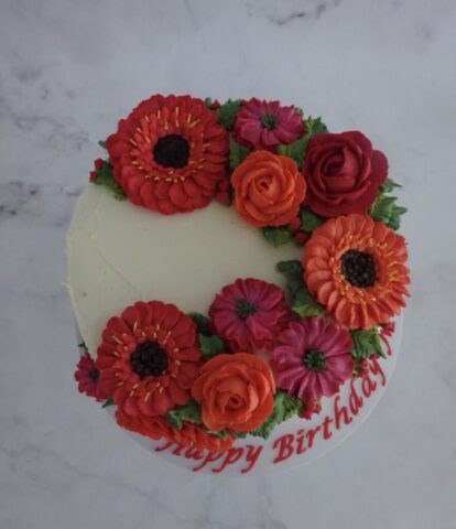 "Cascading Florals Cake Cerise and Orange Top View"